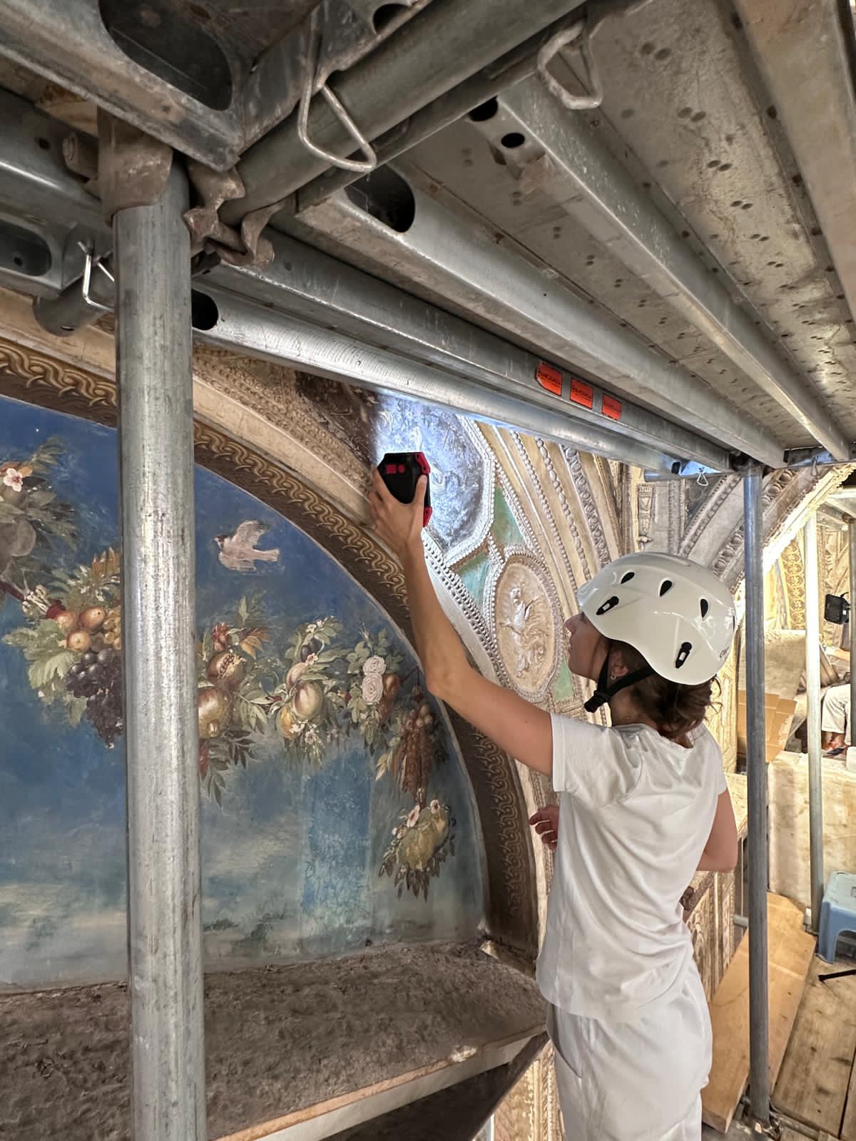A conservator assesses the result of the paint film lifting on the frescoes in the Hall of Raphael in the Vatican’s Apostolic Palace. | Credit: Painting and Wood Materials Restoration Laboratory of the Vatican Museums/Governorate of Vatican City State/Vatican Museums Directorate