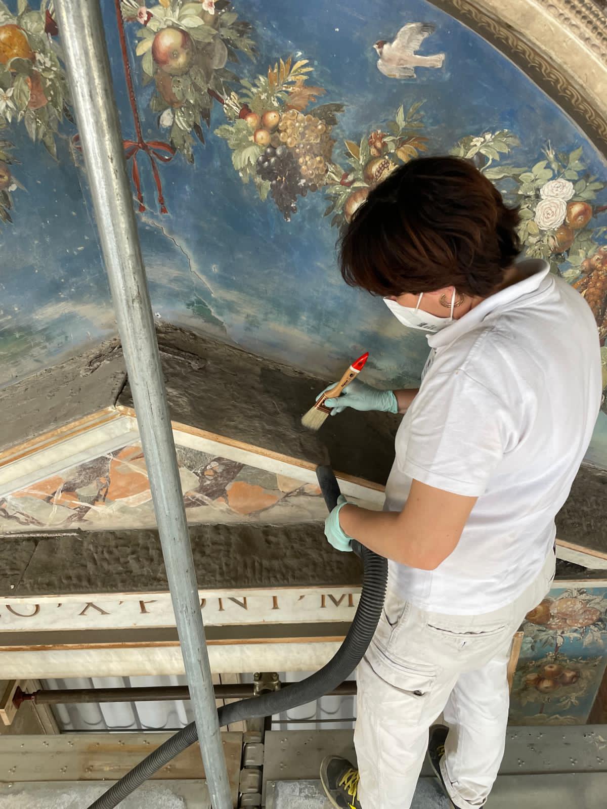 A conservationist removes surface dust from the Hall of Raphael in the Vatican’s Apostolic Palace in June 2026. | Credit: Painting and Wood Materials Restoration Laboratory of the Vatican Museums/Vatican City State Governorate/Vatican Museums Directorate