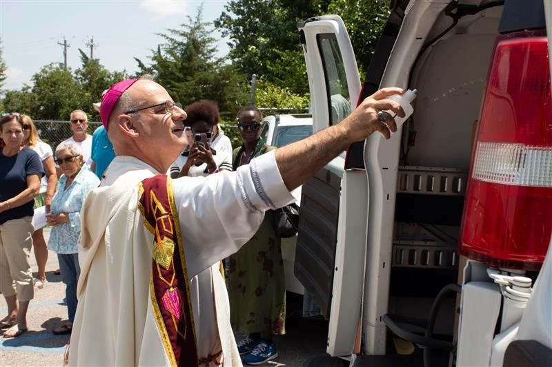 Archbishop Mark Rivituso of Mobile, Alabama, while an auxiliary bishop of St. Louis, blesses donations in a van used during the National Eucharistic Pilgrimage in July 2024. On July 1, 2025, Pope Leo XIV appointed Rivituso archbishop of Mobile, Alabama. | Credit: Jonah McKeown/EWTN News